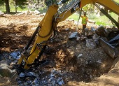 Heavy machinery removing boulders.